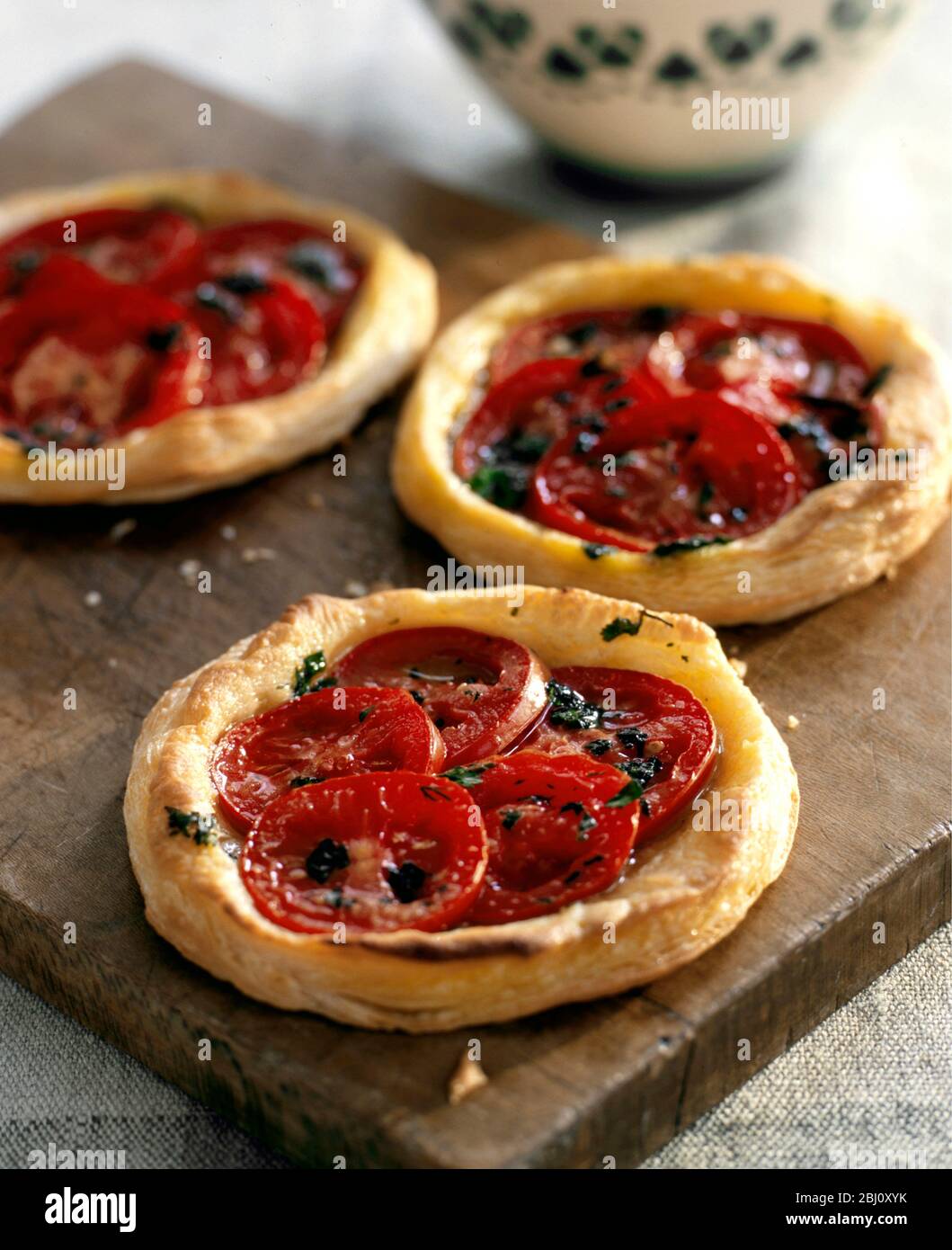 Simple tarts of flaky pastry and fresh tomatoes - Stock Photo