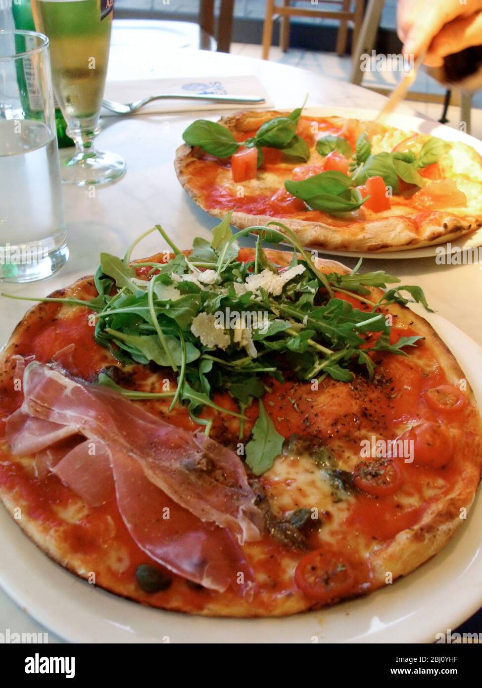 Pizzas in Pizza Express restaurant - Stock Photo