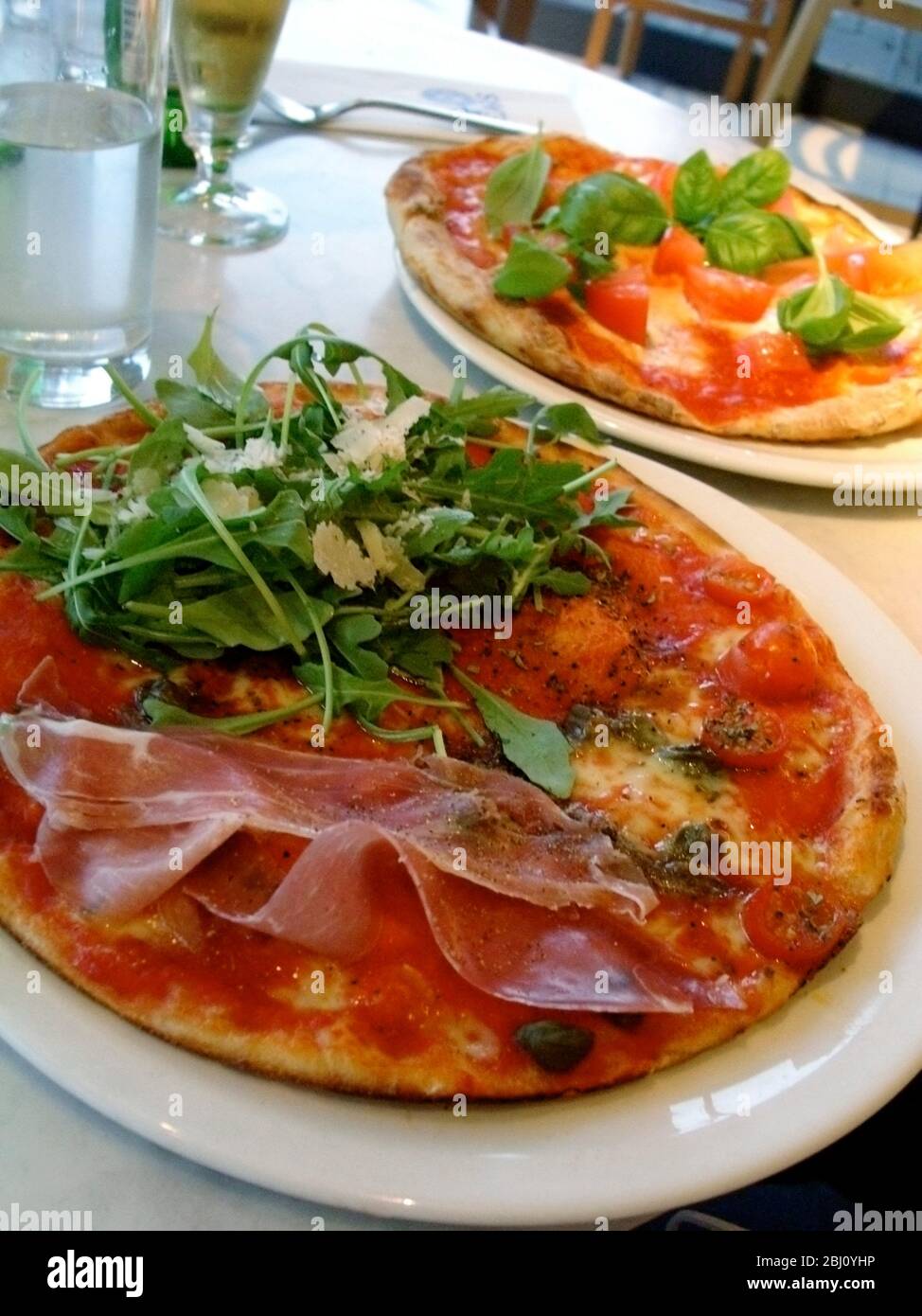 Pizzas in Pizza Express restaurant - Stock Photo