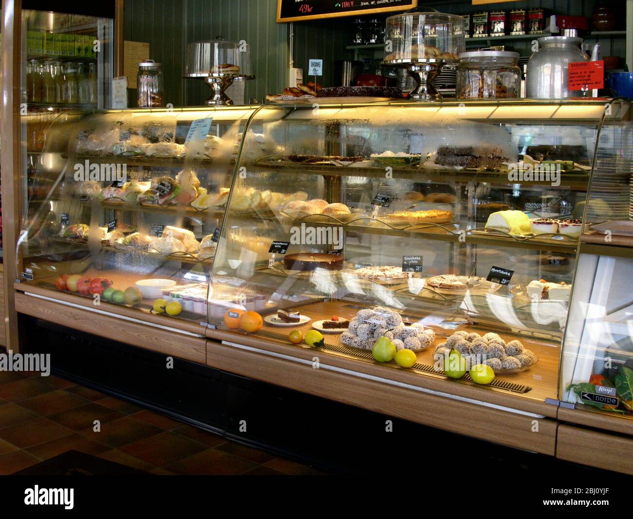 Interior showing pastries fruit and coffee on offer in Cafe Mignon in Varberg, Sweden - Stock Photo