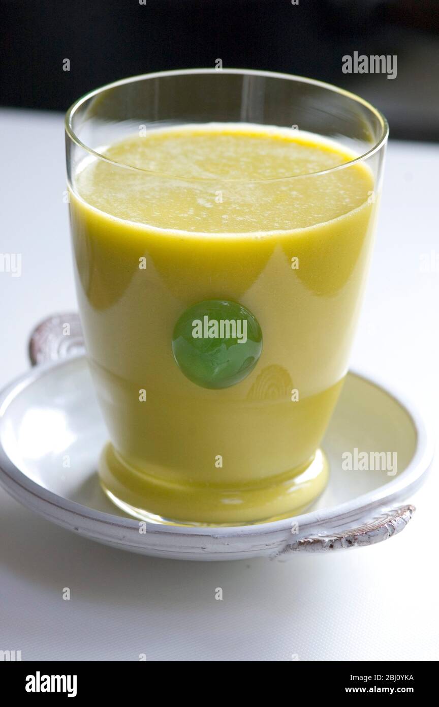 Smoothie made of kiwi fruit and orange juice blended with egg and honey