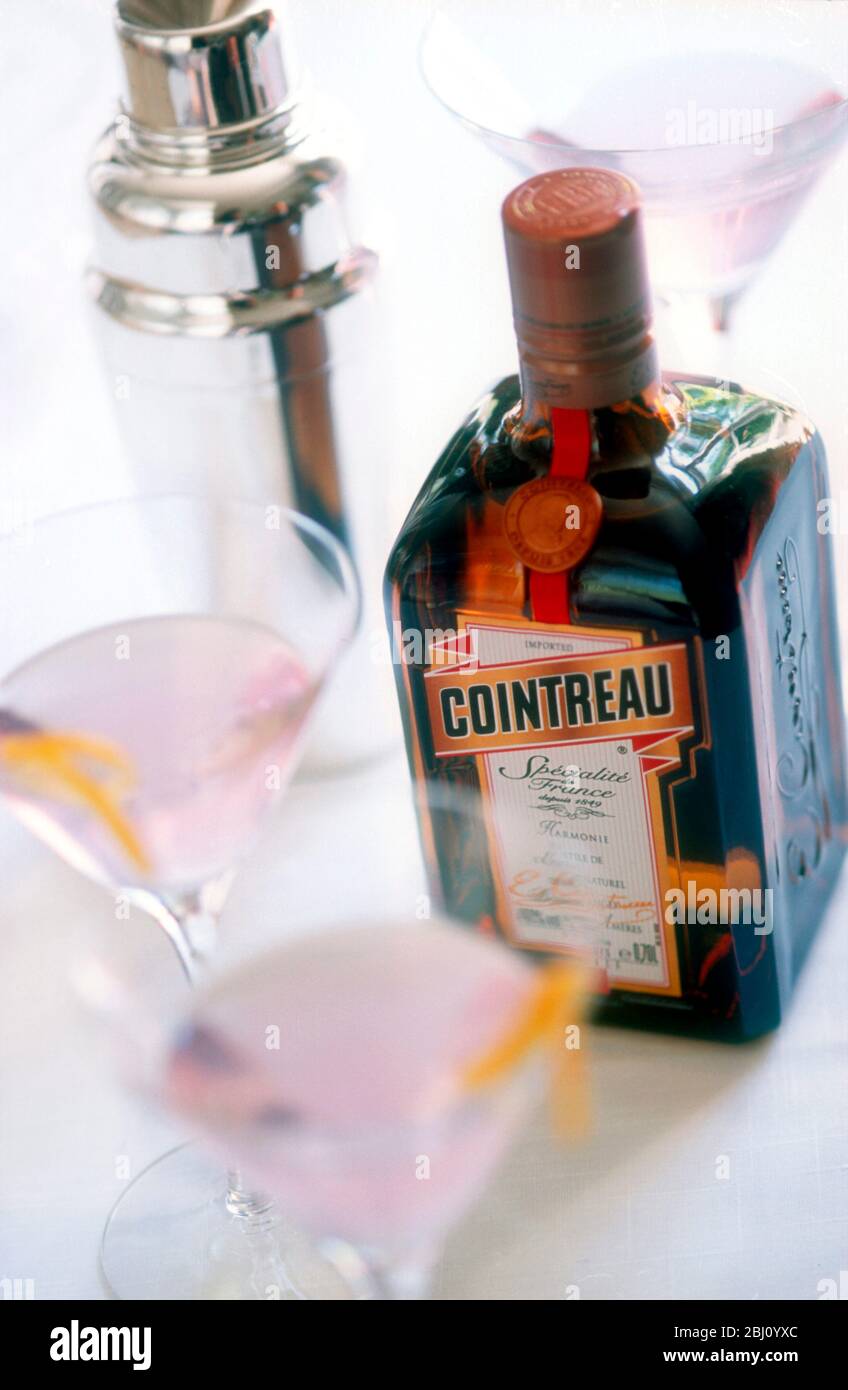 Cointreau Cosmopolitan 1 part Cointreau 2 parts vodka Juice of 1/2 lime Splash of cranberry juice Strain into a chilled Martini glass Garnish with a t Stock Photo