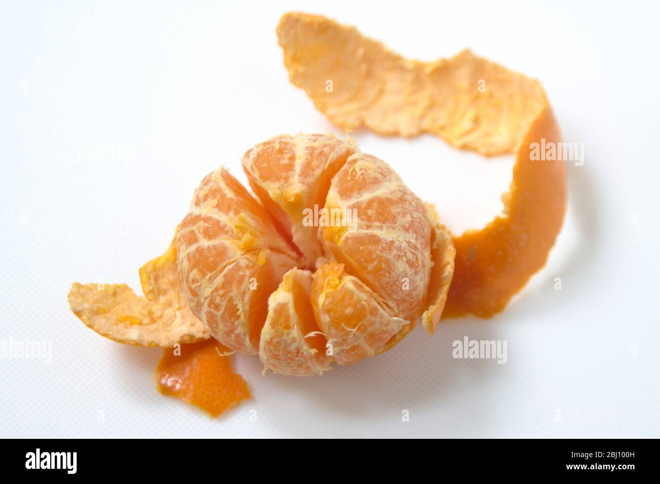 Peeled satsuma on white surface Stock Photo Alamy