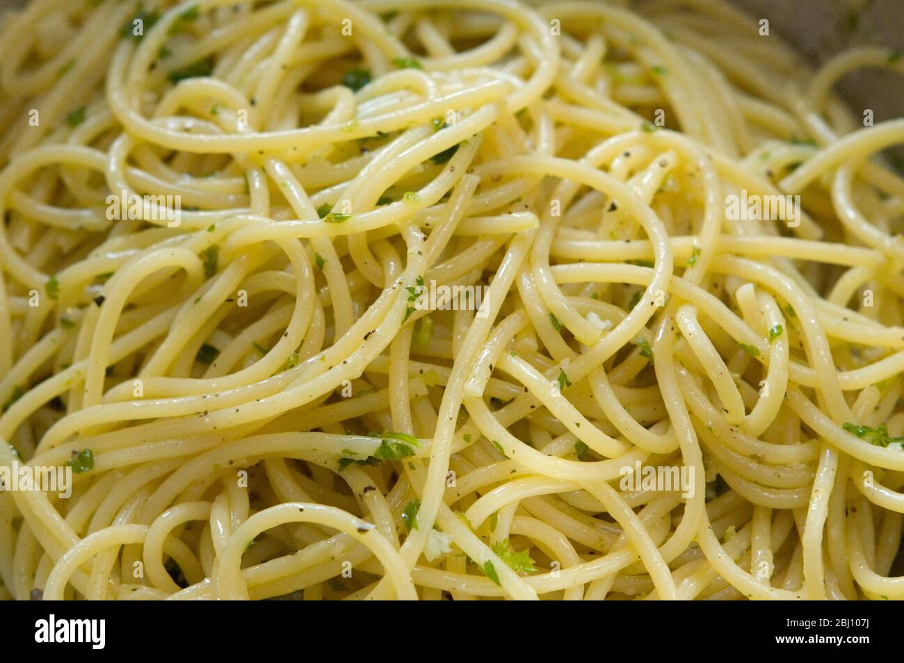 Spaghetti freshly cooked and dressed simply with olive oil, salt and