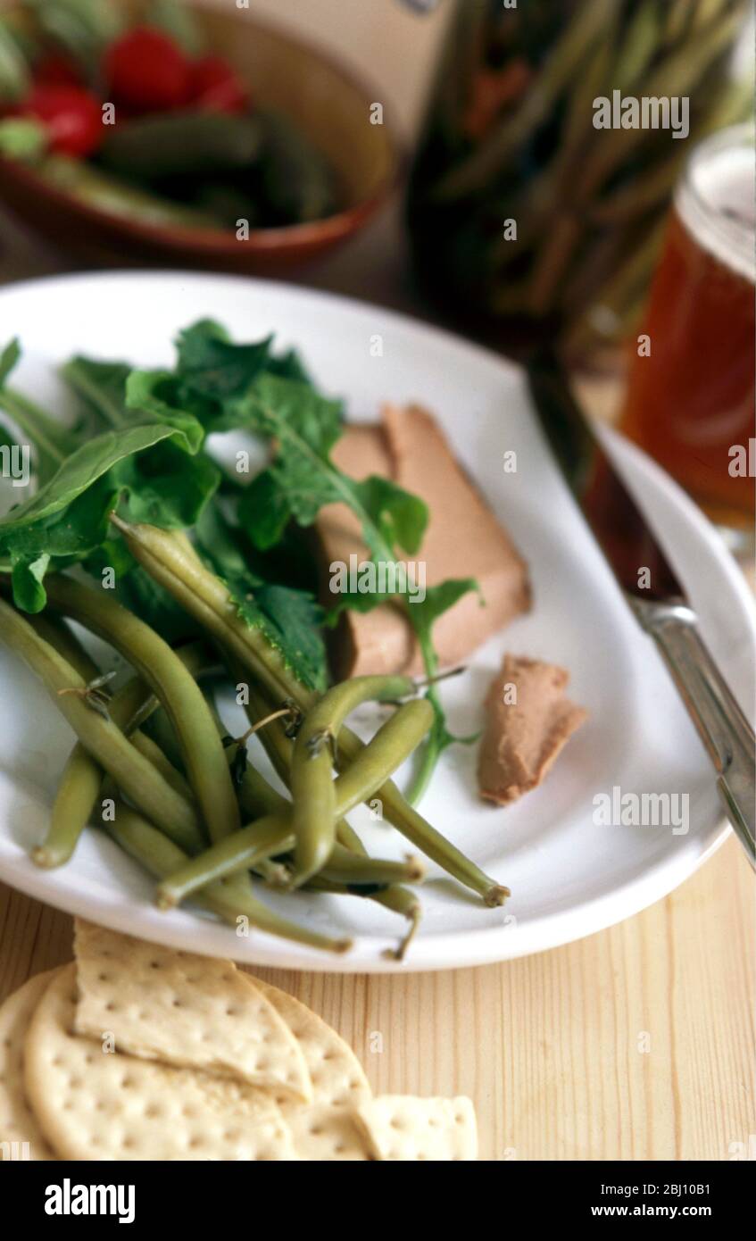 Salad of pickled beans with rocket served with a smooth liver pate - Stock Photo