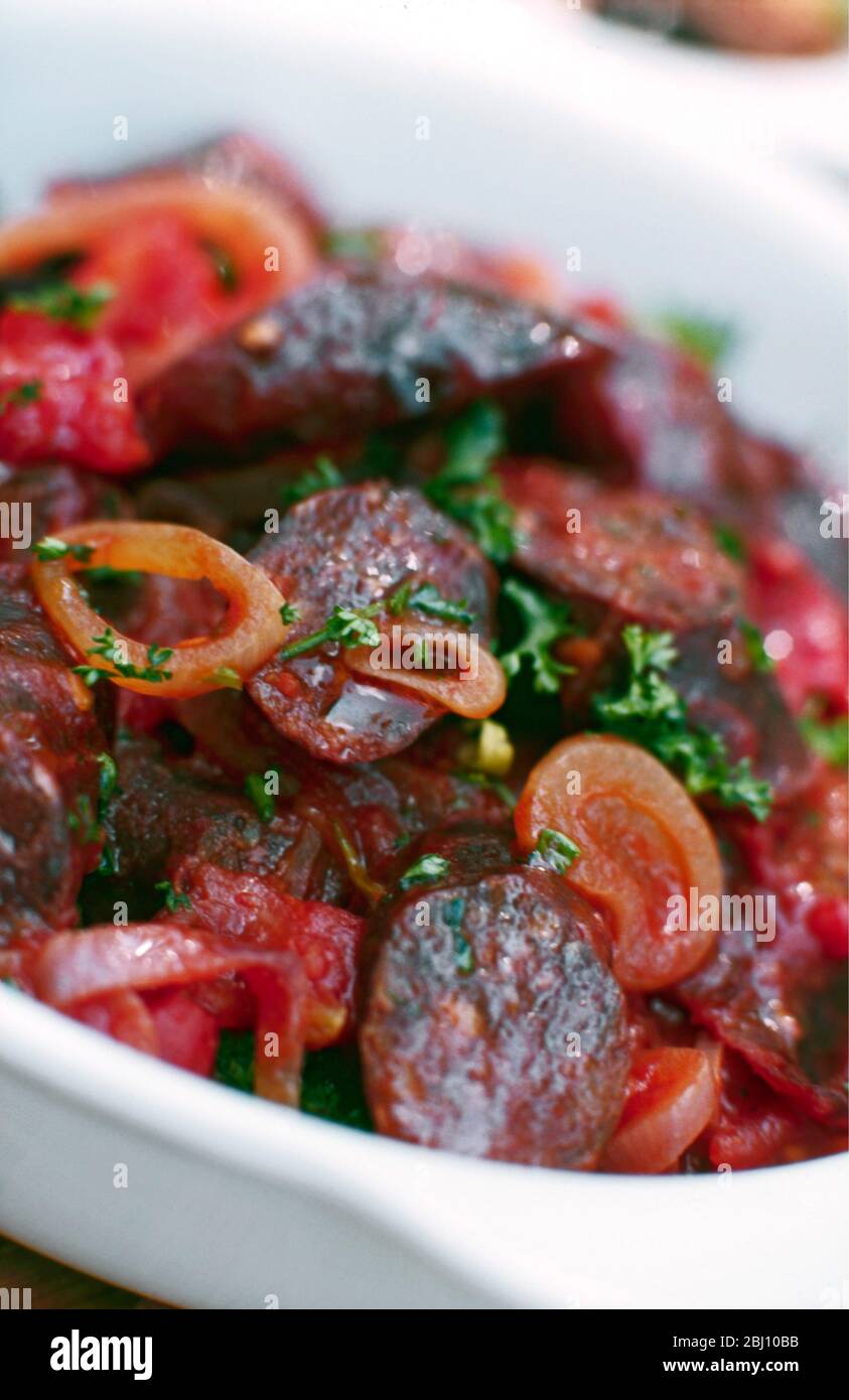 Salad of spicy French sausage with onion and parsley - Stock Photo