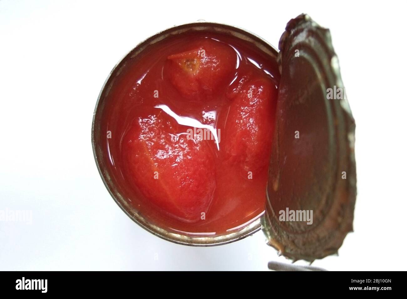 Opened can of plum tomatoes seen from above - Stock Photo