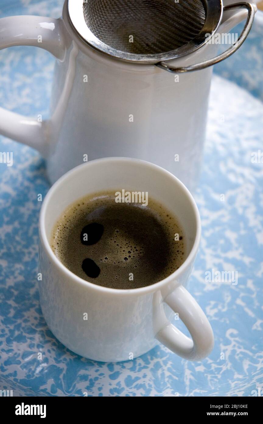 Real coffee made simply in jug with tea strainer Stock Photo Alamy
