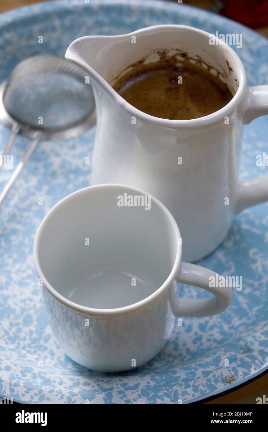 Real coffee made simply in jug with tea strainer Stock Photo Alamy