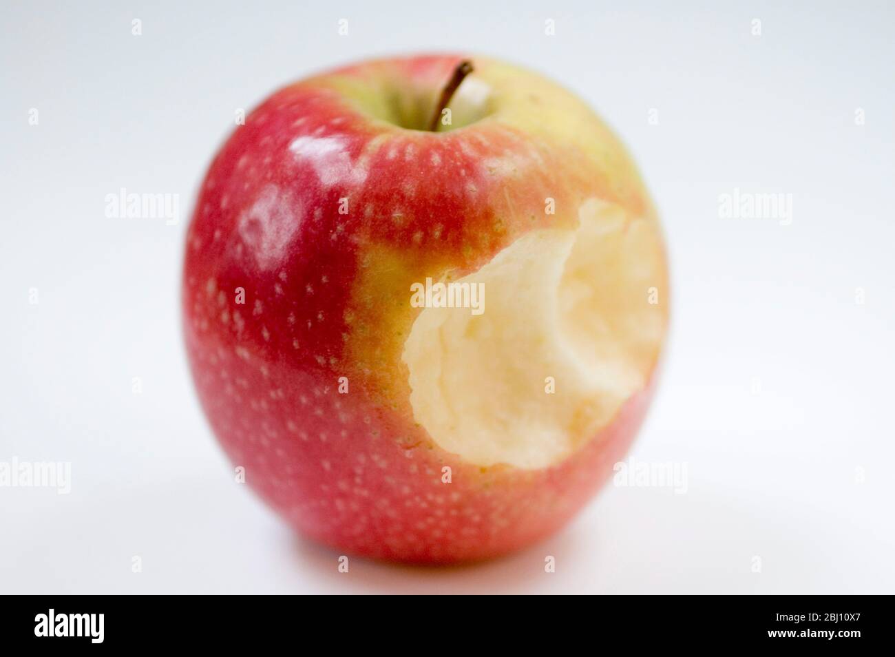 One shiny red eating apple with bite out - Stock Photo
