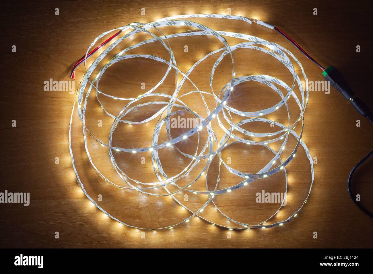 LED strip on a wooden table, close-up Stock Photo