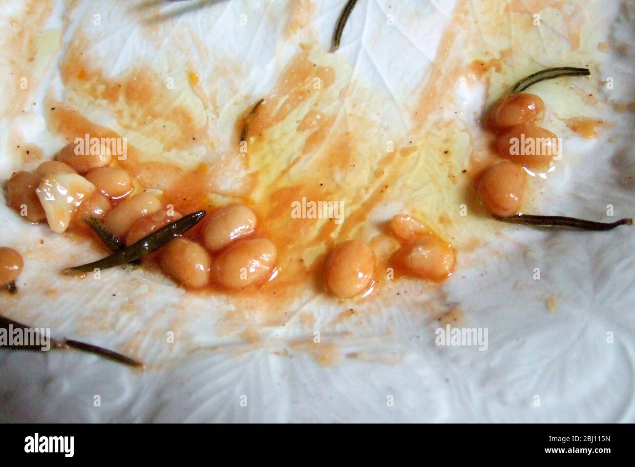 The end of the meal - bean and roast vegetable casserole with garlic and rosemary - Stock Photo