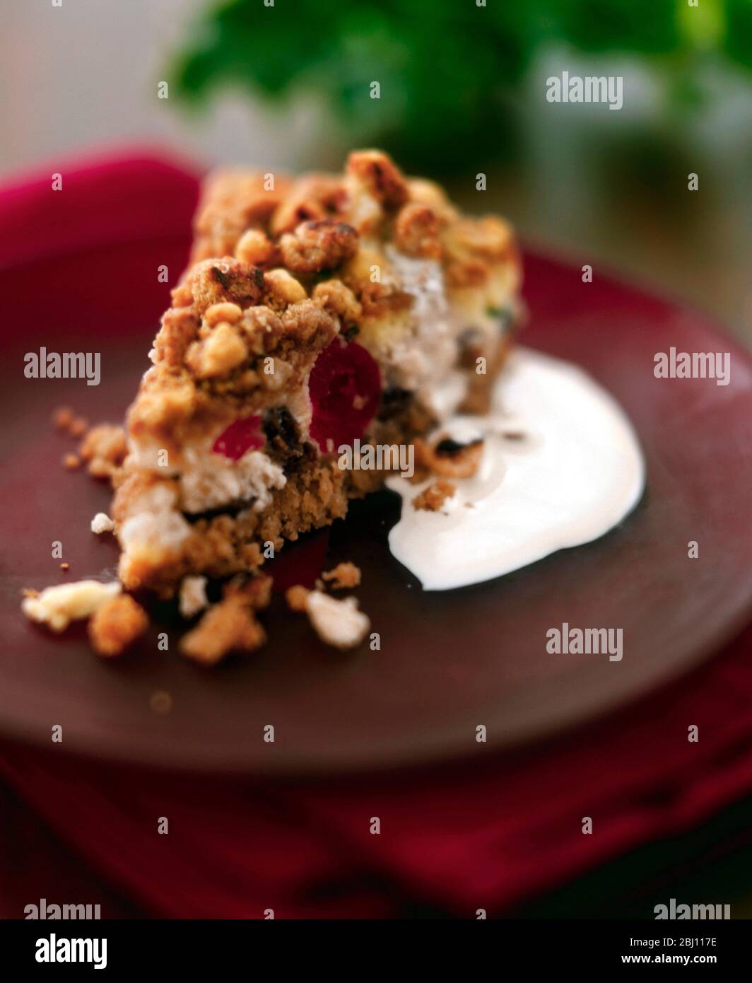 Crunchy topped cherry cheesecake on biscuit crumb base - Stock Photo