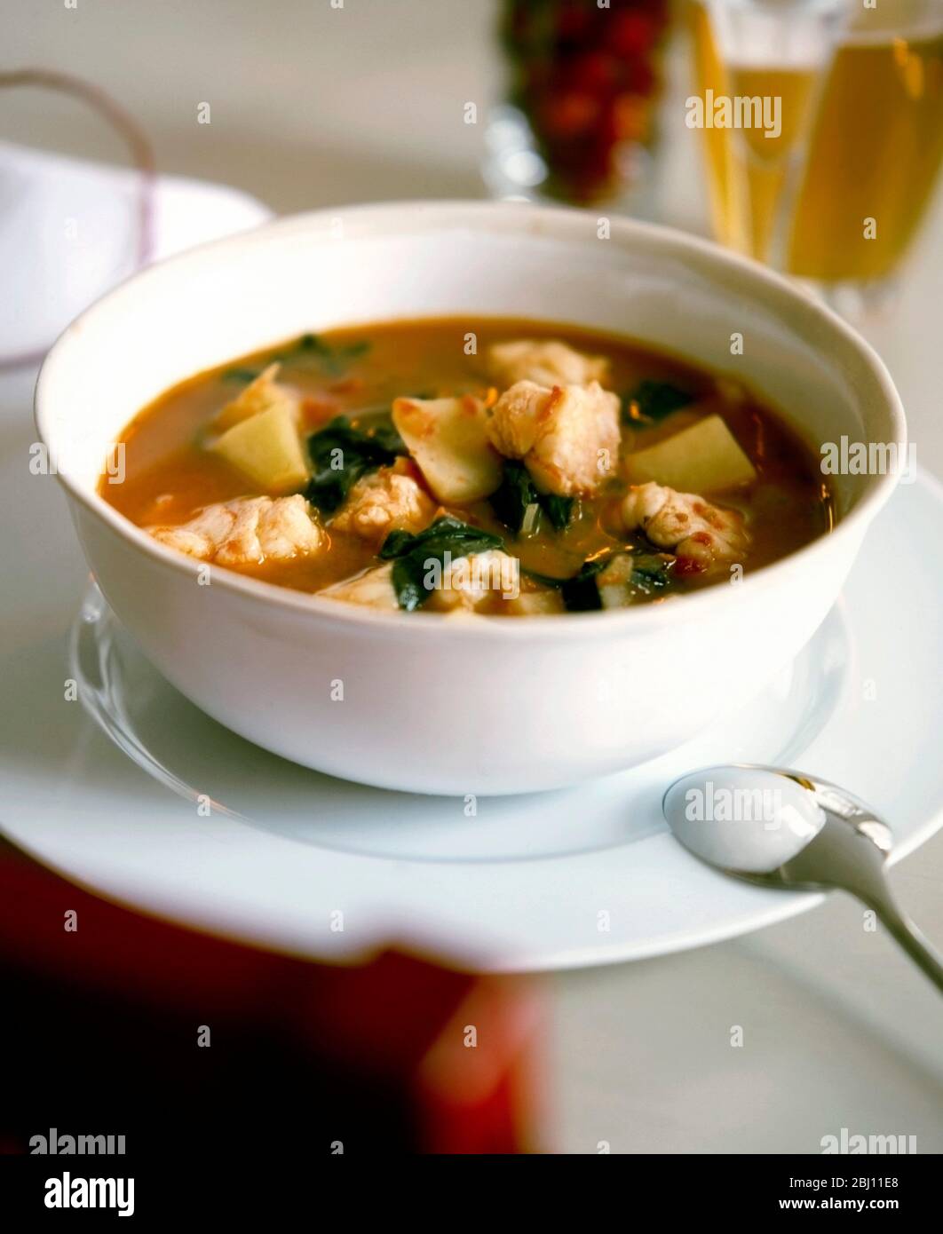 Spicy fish soup or stew with monkfish and vegetables - Stock Photo