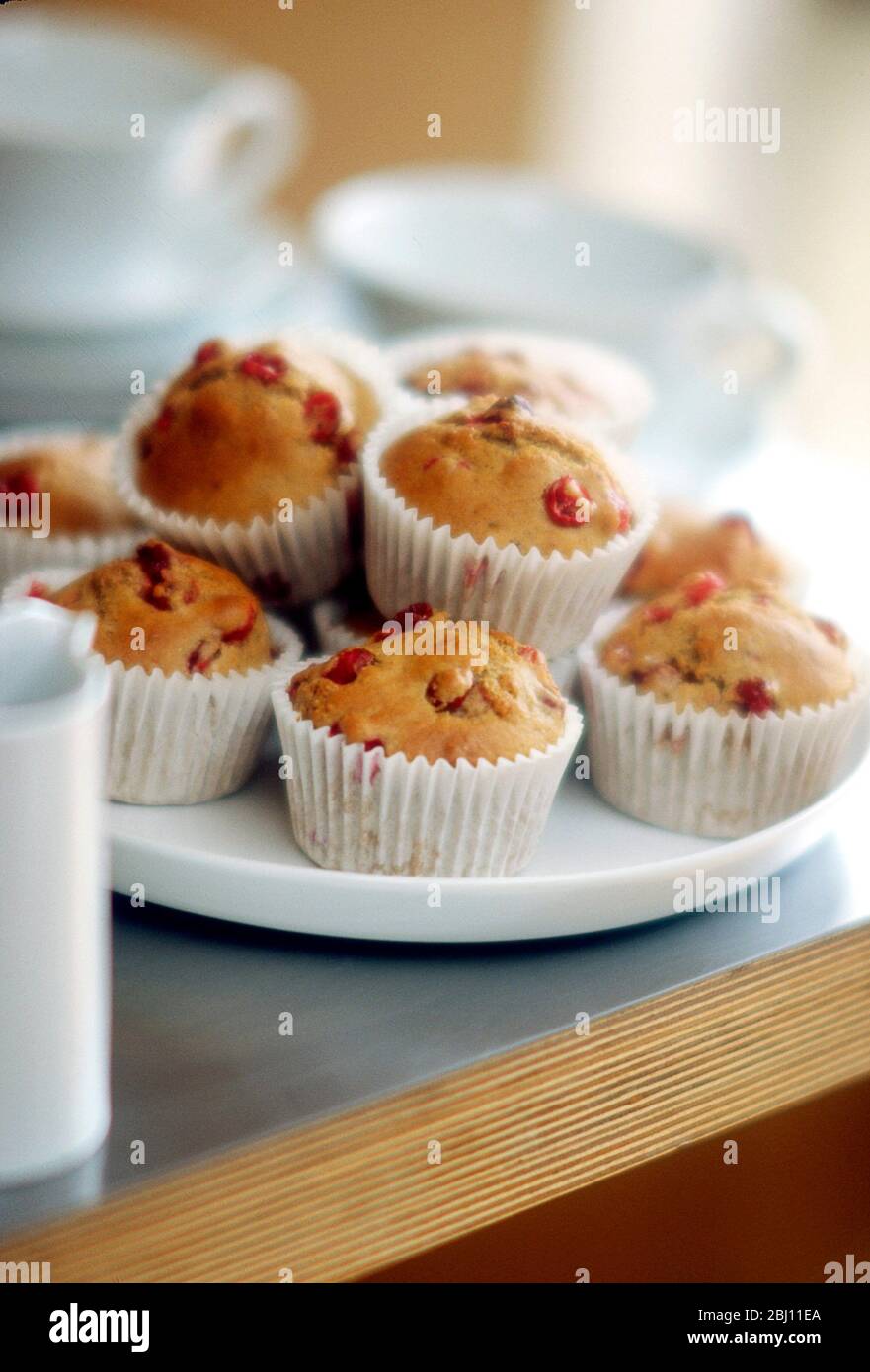 Cherry muffins in teatime setting - Stock Photo
