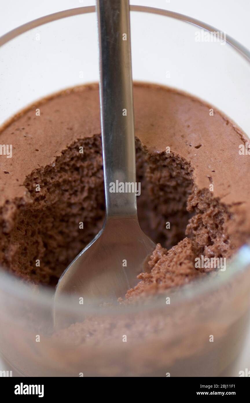 Spoon in chocolate moccha mousse dessert, in glass tumbler - Stock Photo