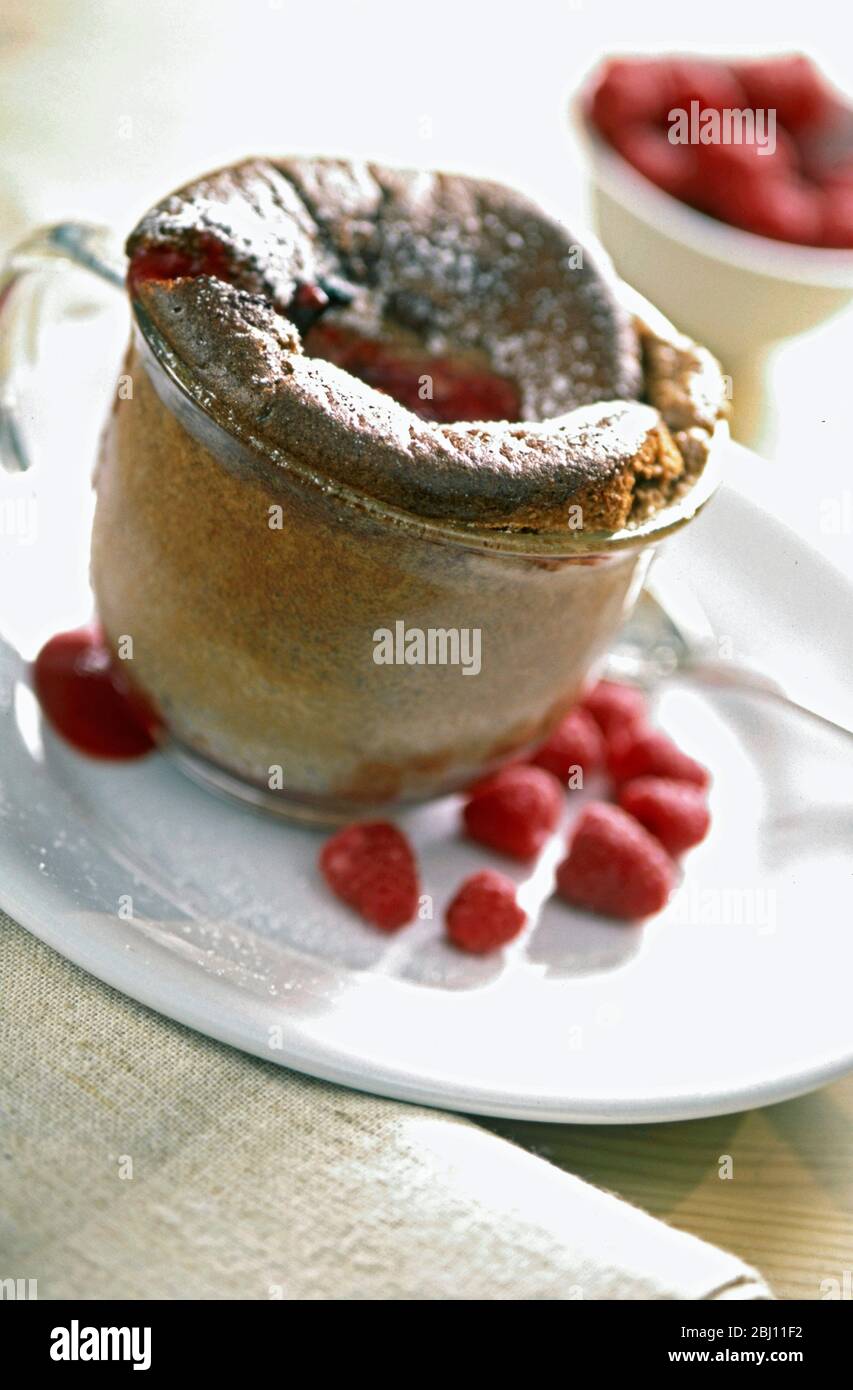 Small souffle pudding baked in glass cup - Stock Photo