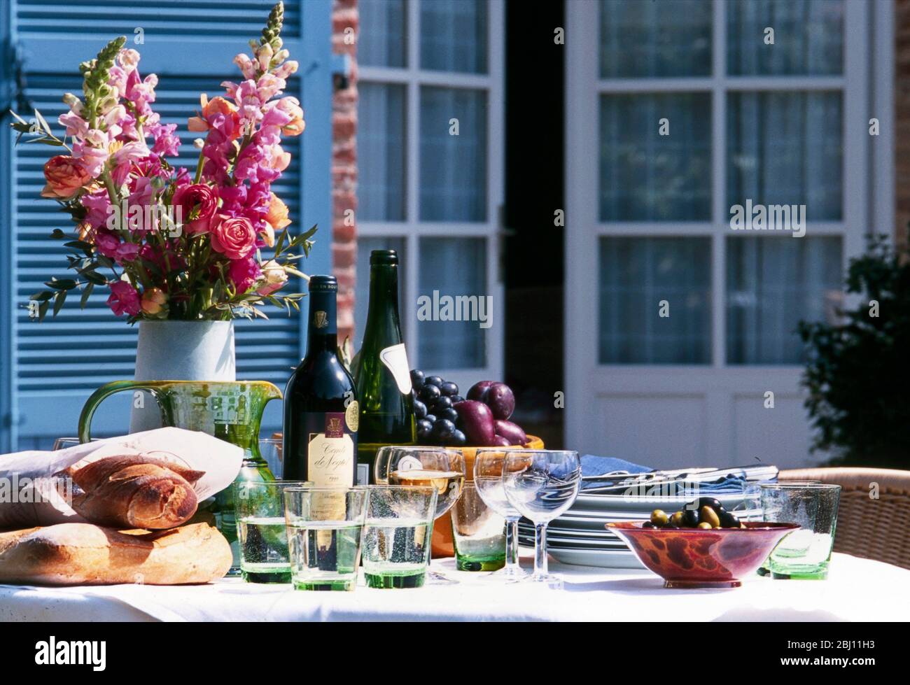 Table set outside for light summer lunch - Stock Photo
