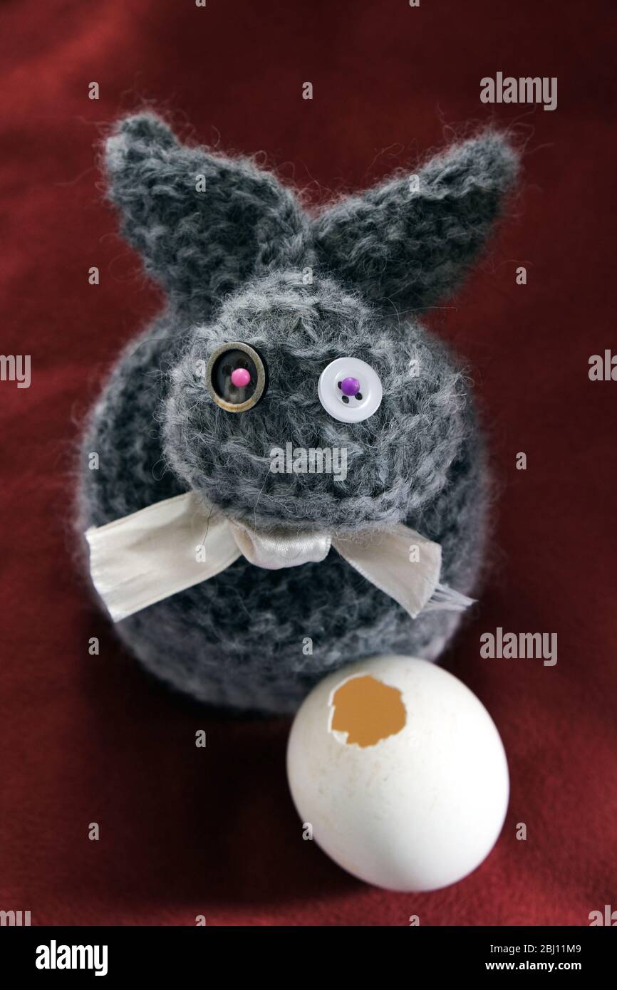 wool bunny with pierced egg Stock Photo