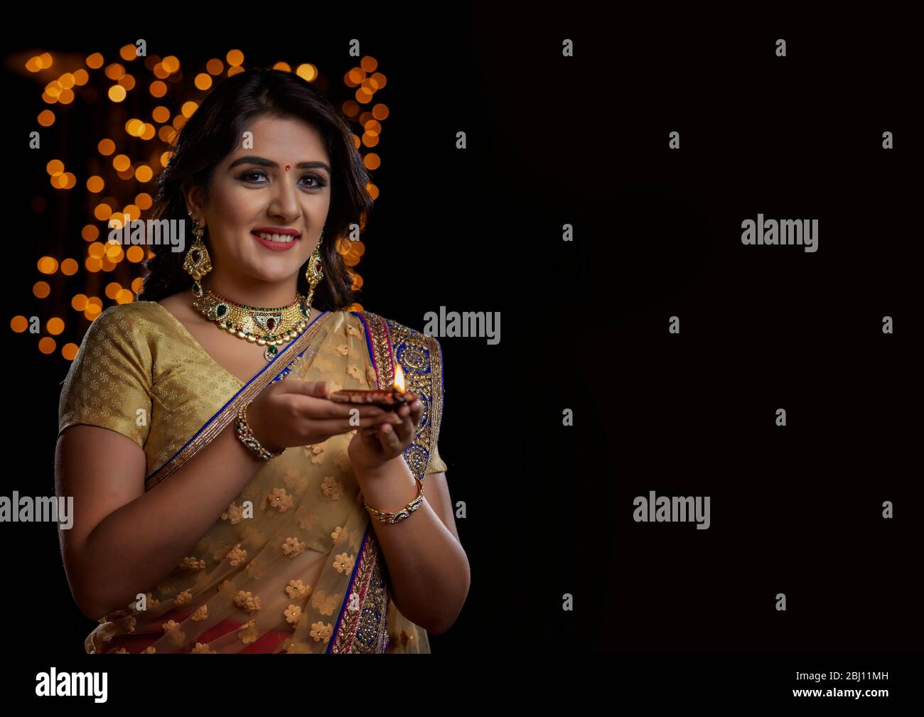 Woman in saree holding hi-res stock photography and images - Alamy