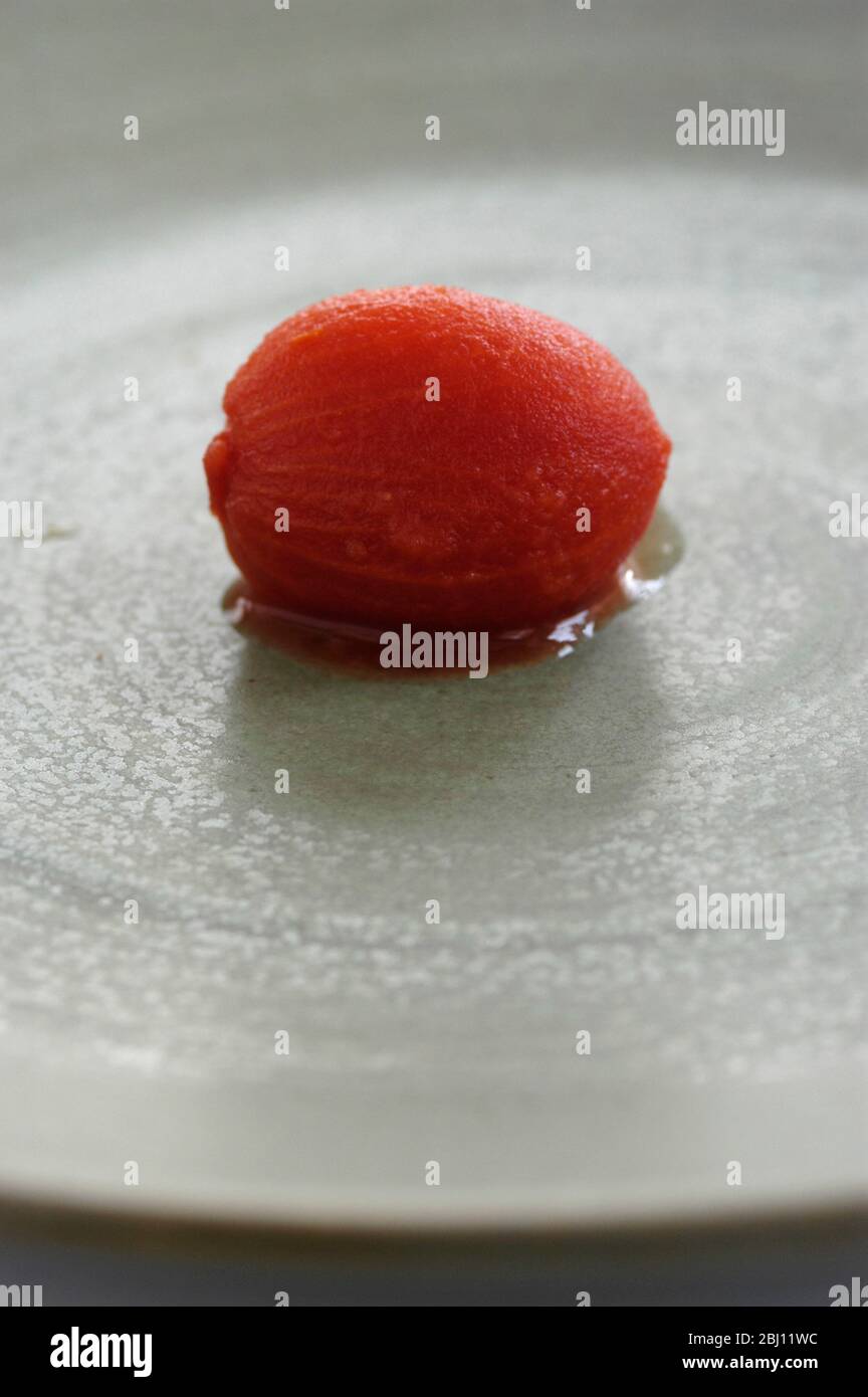 Single plum tomato from can - Stock Photo
