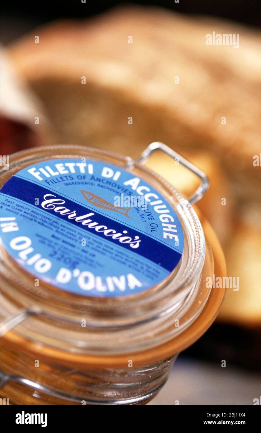 Top of jar of fillets anchovies in olive oil from Antonio Carluccio's delicatessen store - Stock Photo