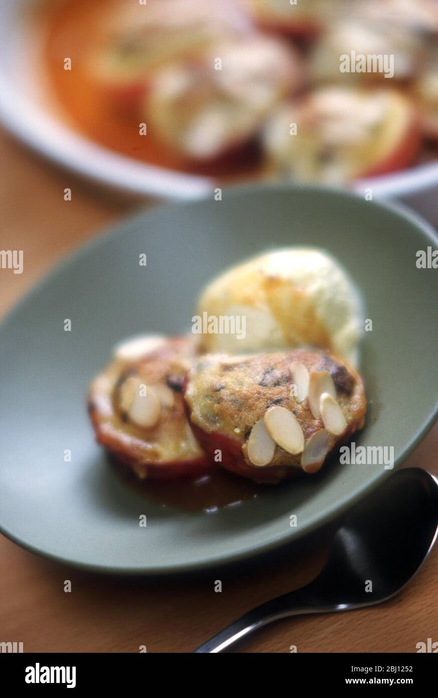 Baked peaches with almond topping - Stock Photo