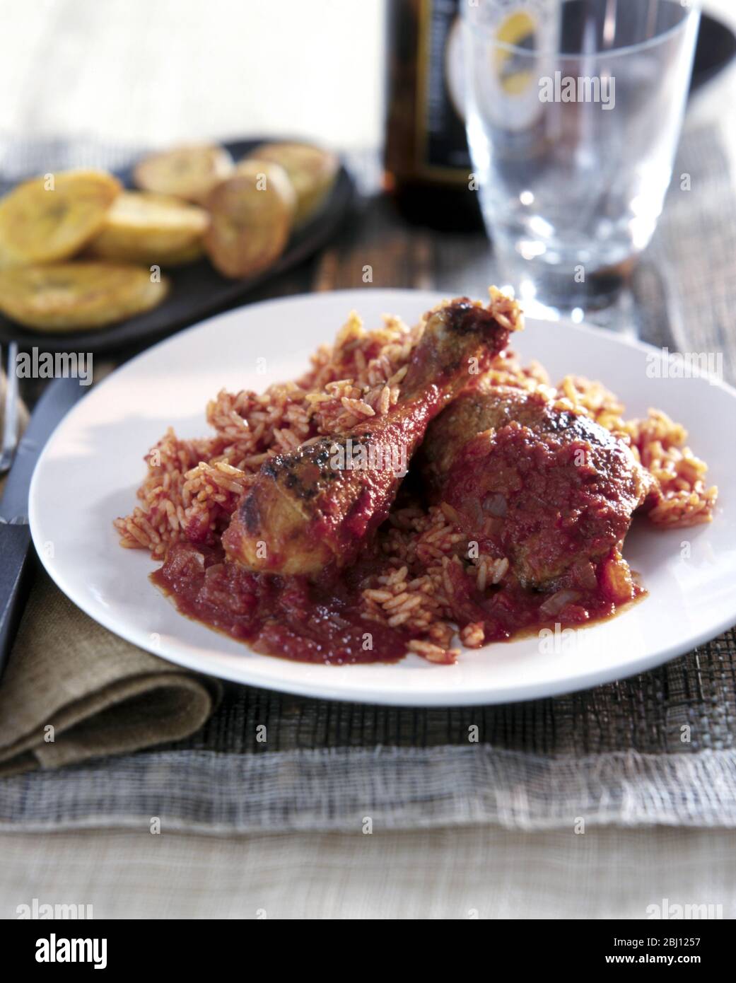 Spiced fried chicken with rice and plantain - Stock Photo