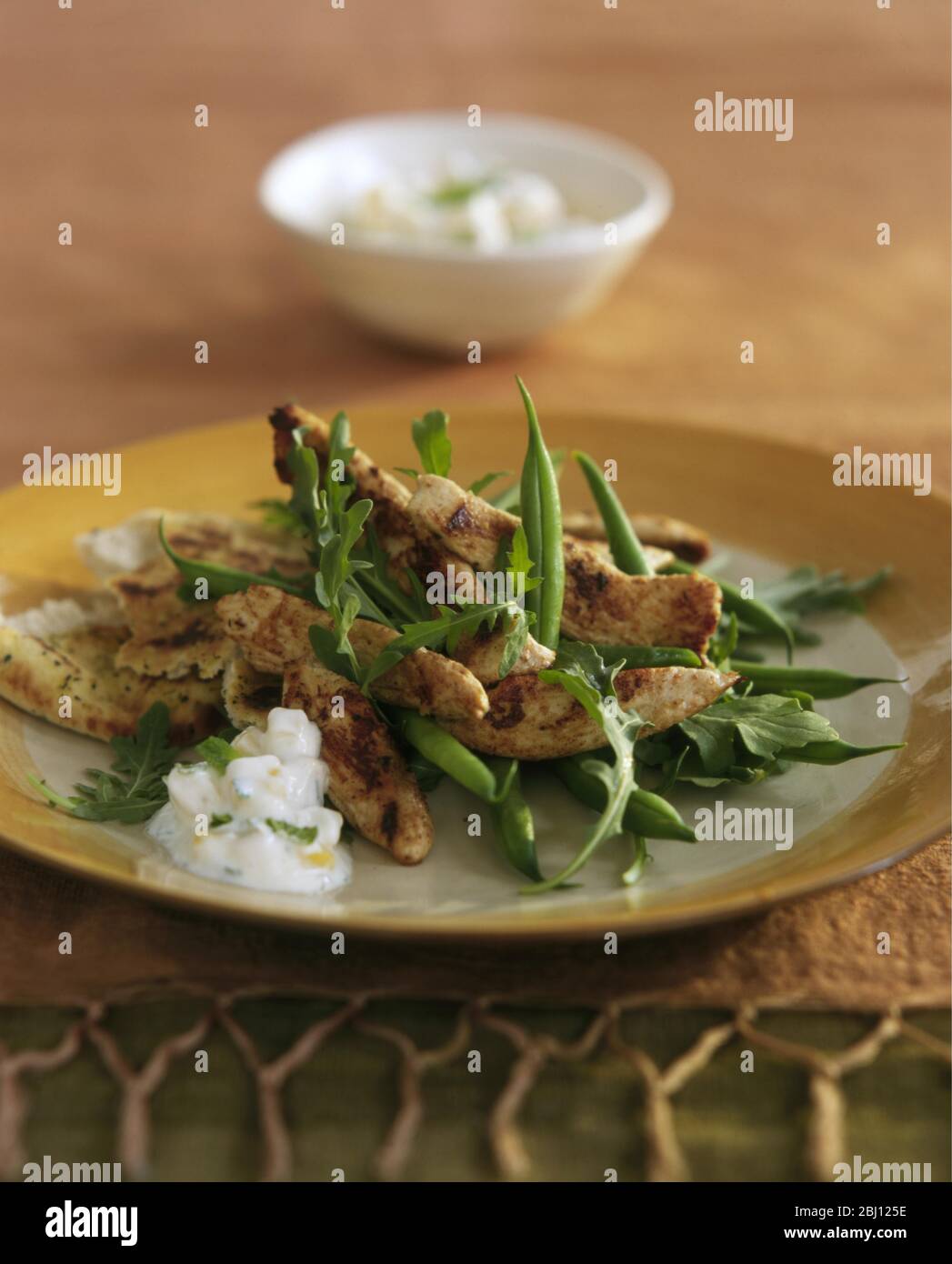 Salad of chicken goujons, green beans and rocket - Stock Photo