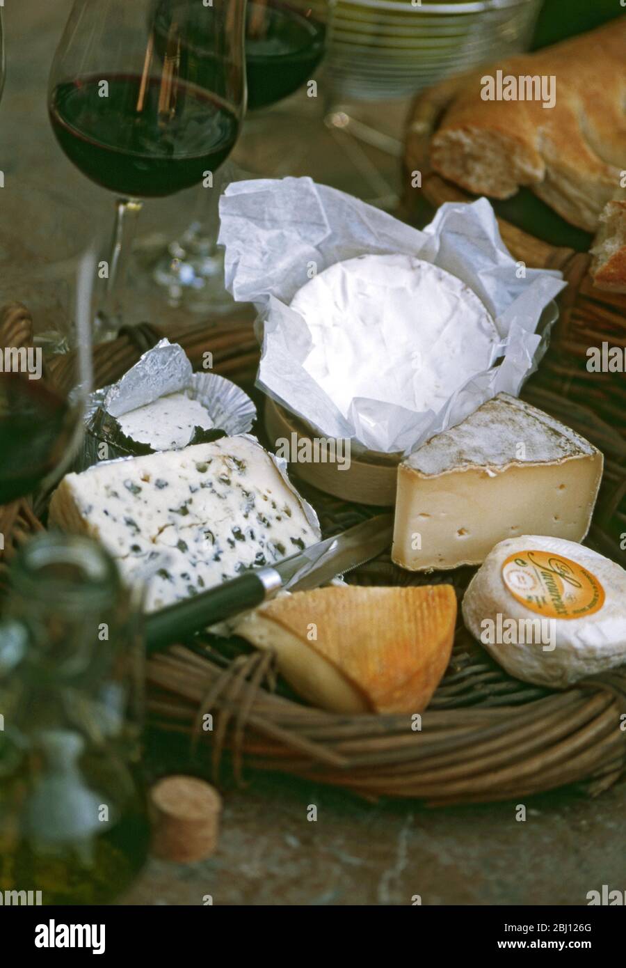 Rustic cheeseboard with selection of French cheeses - Stock Photo