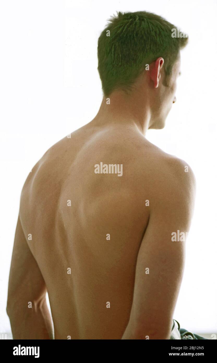 Young man showing well developed back - Stock Photo