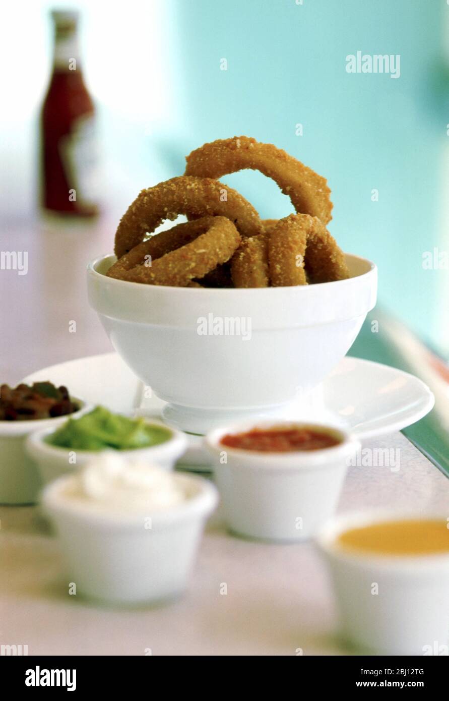 Onion rings and dips - Stock Photo