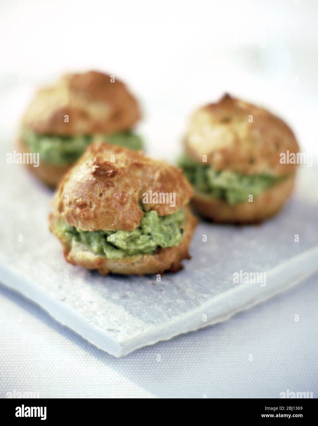 Choux buns with avocado - Stock Photo