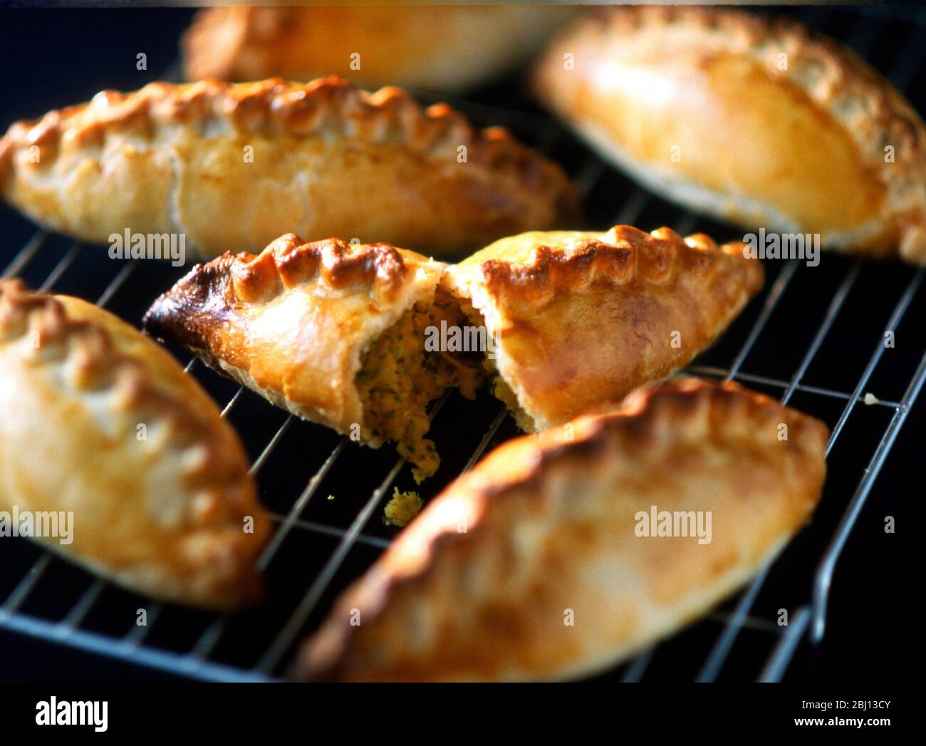 Cornish pasties on rack on oven - Stock Photo