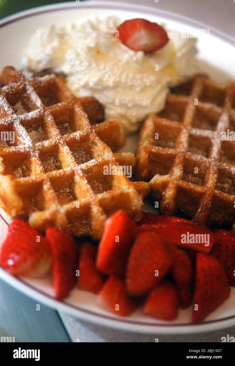 Waffles with strawberries and cream - Stock Photo