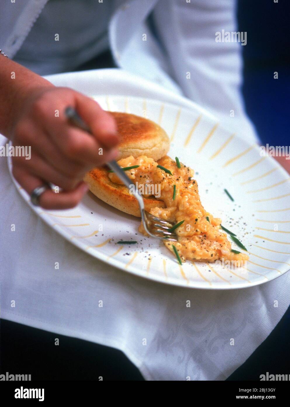 Eating scrambled eggs - Stock Photo