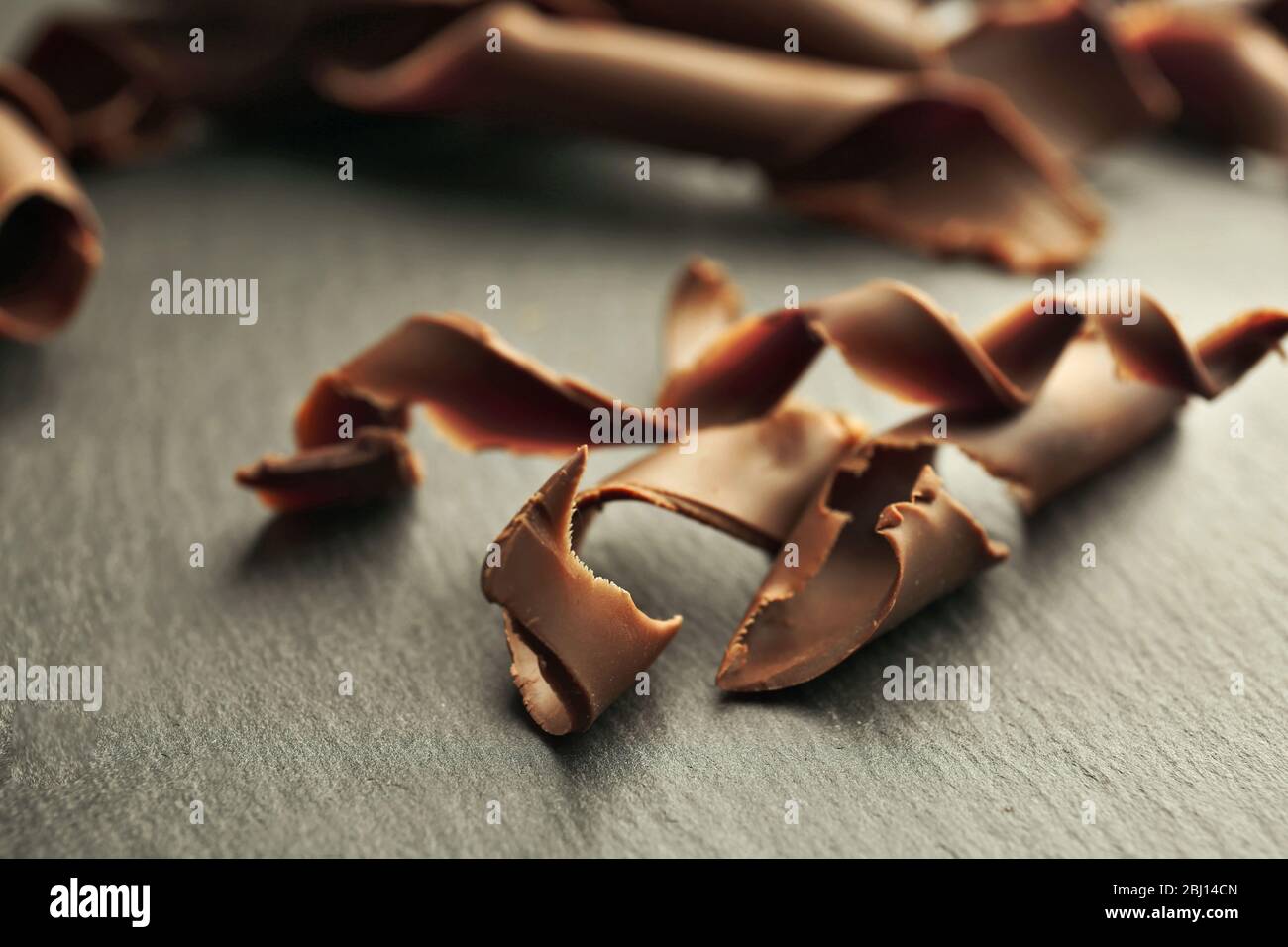 Chocolate curls on wooden table close up Stock Photo - Alamy