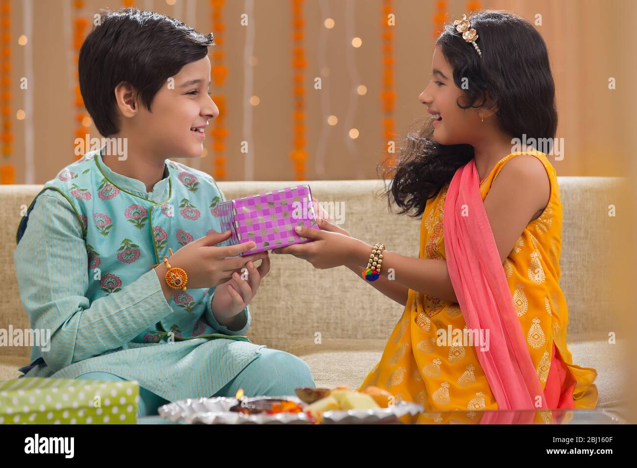 Sister Giving Present To Her Brother Stock Photo Alamy