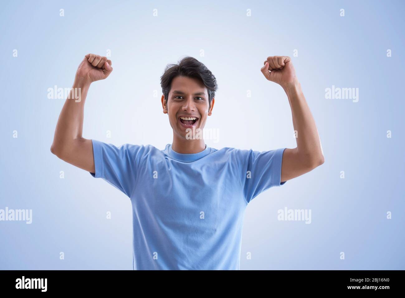 young man clenching fists and cheering Stock Photo