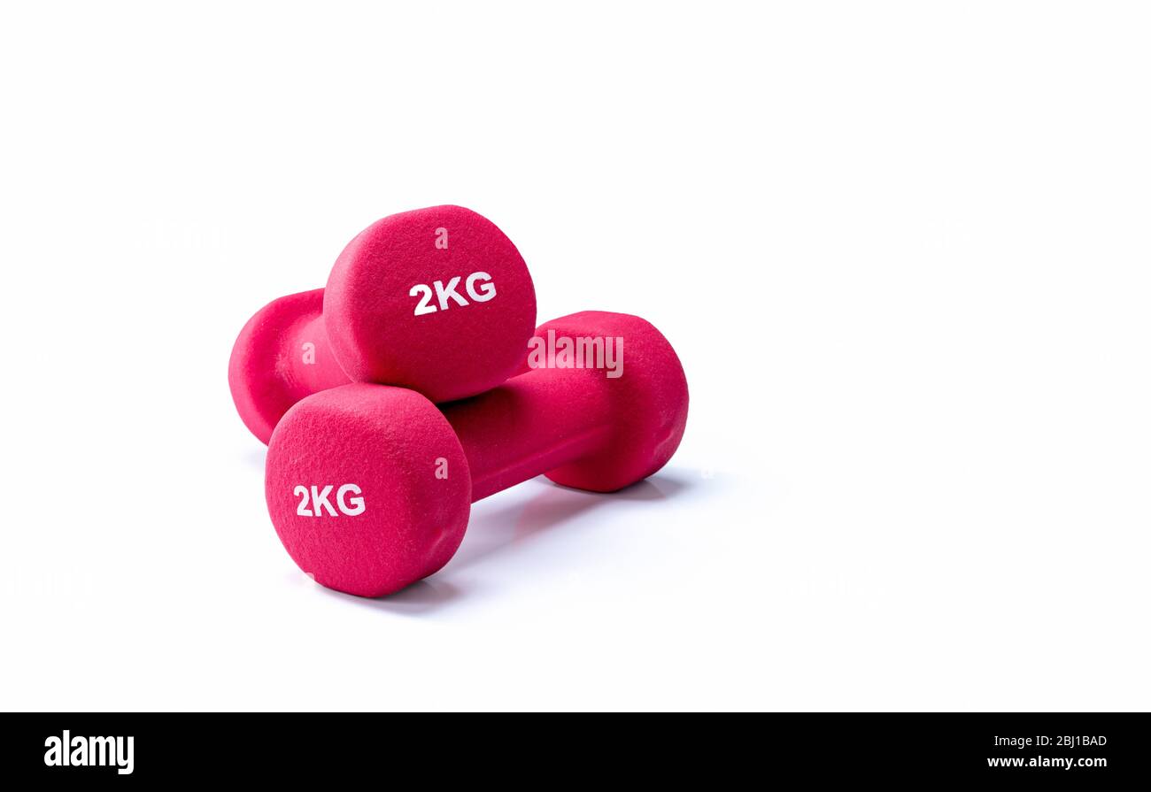 Set of red dumbbells isolated on white background. A pair of red neoprene dumbbells. Home gym equipment for exercise at home. Weight training Stock Photo