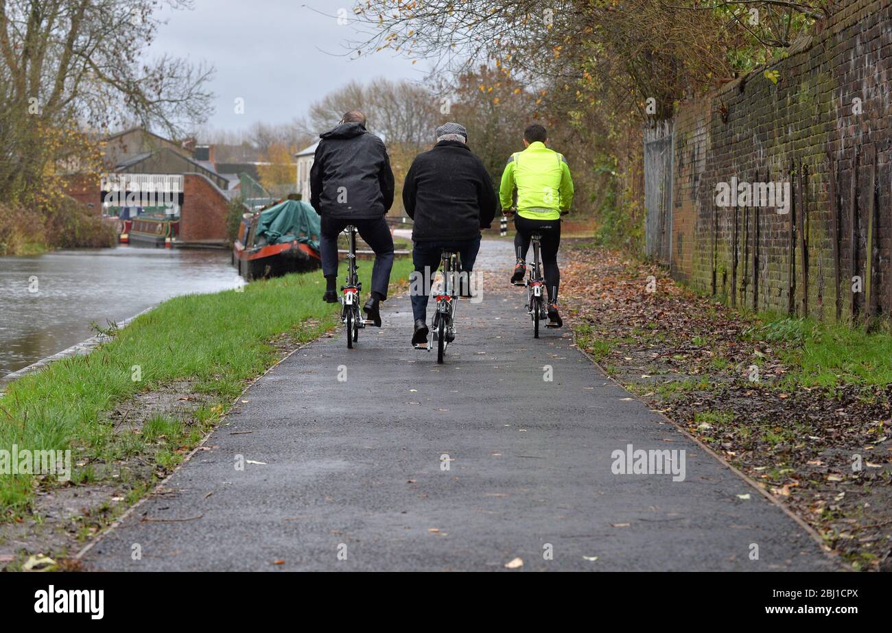 3 people cycling along a tow path near to Strourbridge in the West Midlands, England, UK. Stock Photo