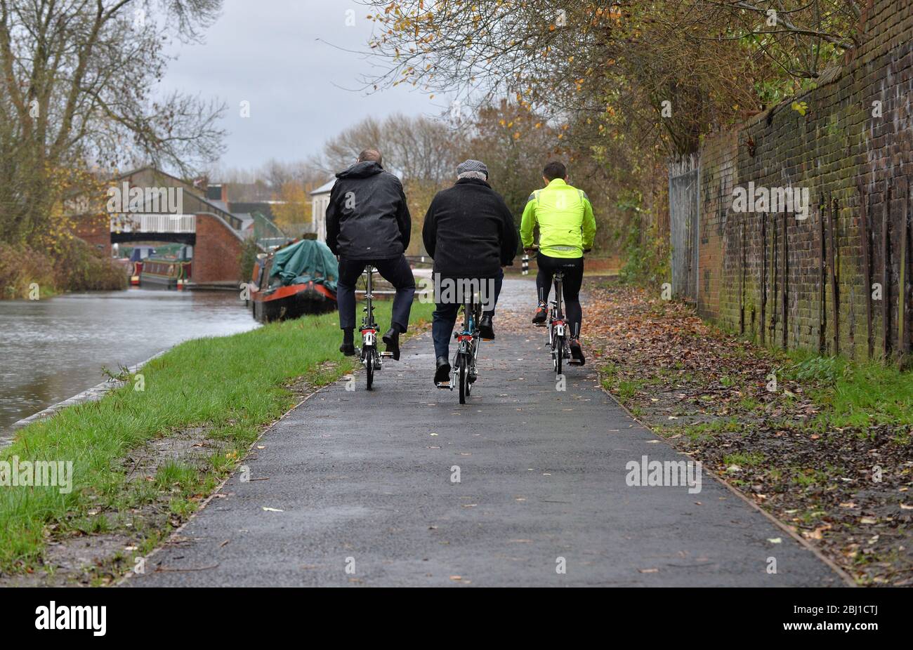 3 people cycling along a tow path near to Strourbridge in the West Midlands, England, UK. Stock Photo