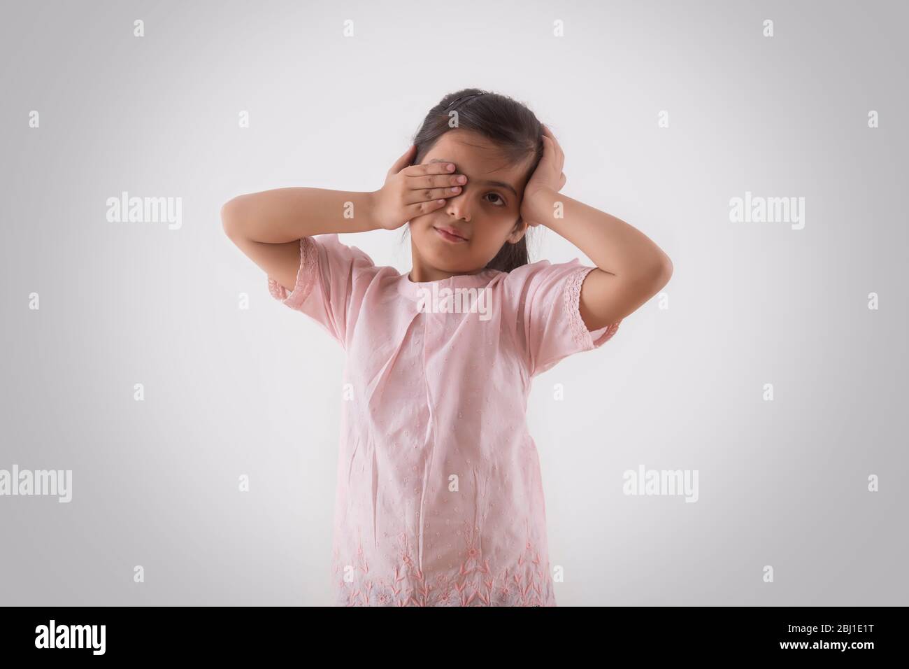 portrait of a young girl rubbing her eyes Stock Photo
