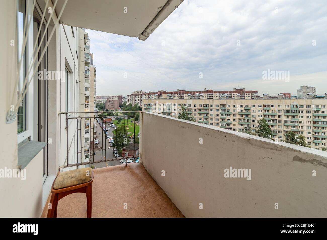 Old common open balcony in high residential apartment building maid of