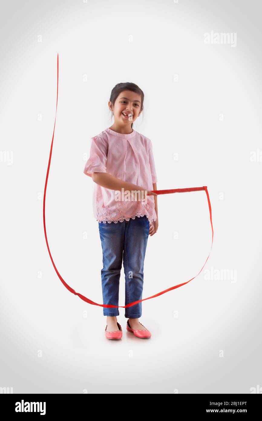 young girl playing with a ribbon wand Stock Photo