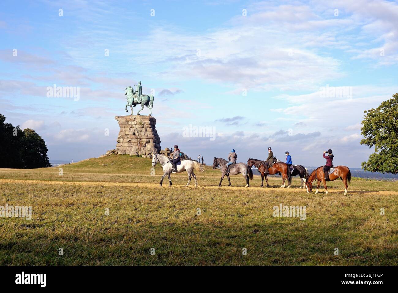 Horse riders approaching the Copper Horse equestrian statue of King George third, Snow hill Windsor Great Park Berkshire England UK Stock Photo
