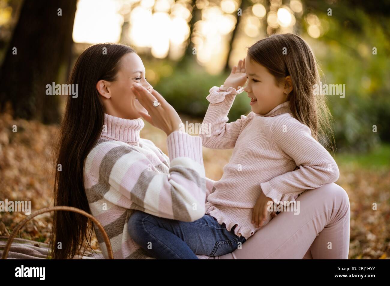 Mother and daughter enjoying autumn in park Stock Photo - Alamy