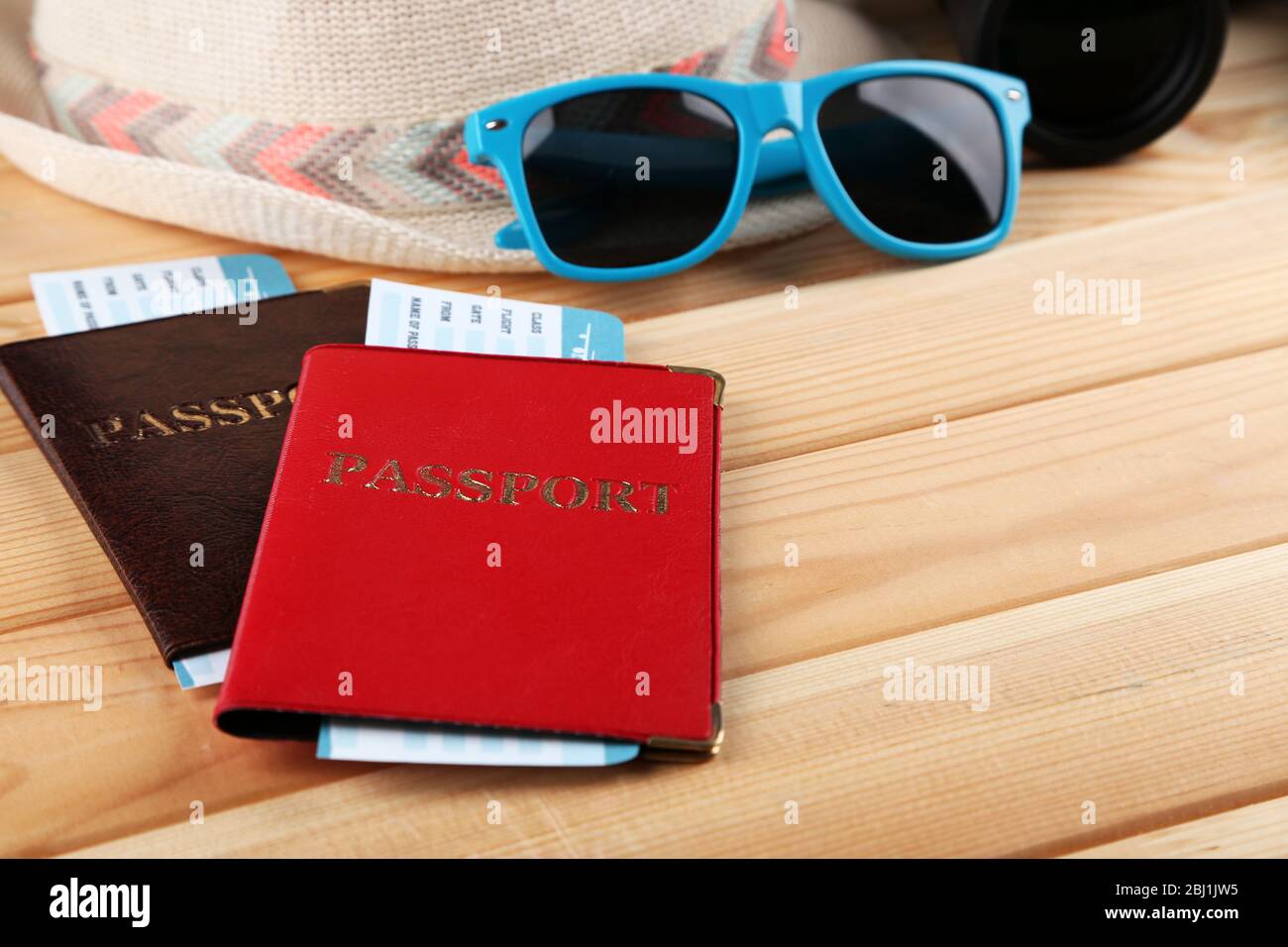 Sunglasses, passports and tickets, close up, on wooden background. Preparing for travel concept Stock Photo