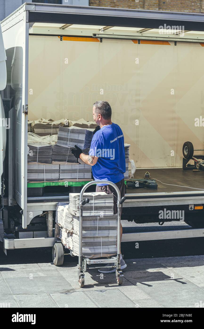 London/UK-1/08/18: man unloading the London Evening Standard at The Quadrant in Richmond. The Evening Standard is a local, free daily newspaper, publi Stock Photo