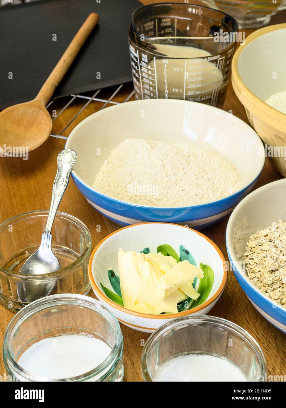 Ingredients for making oat bread on a kitchen table Stock Photo